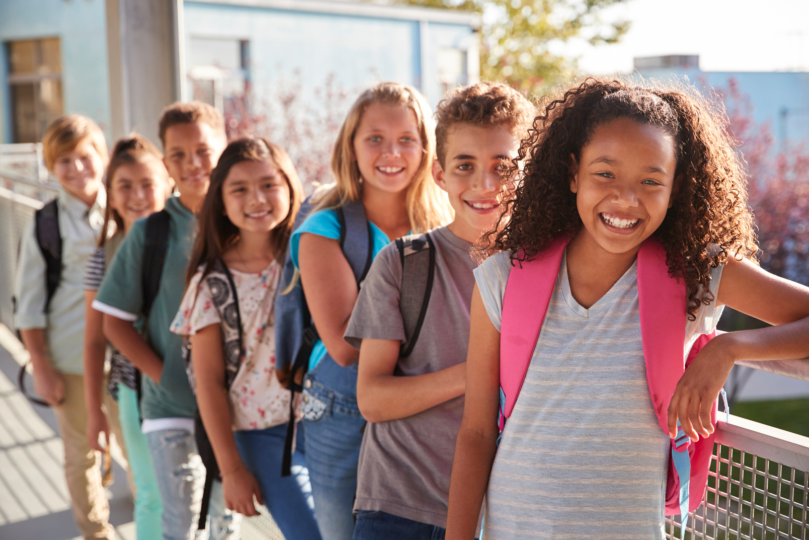 Elementary School Kids with Backpacks Smiling at the Camera